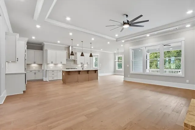 a kitchen with stainless steel appliances a stove a sink a refrigerator and microwave