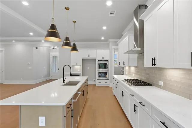 a kitchen with a sink stove and refrigerator