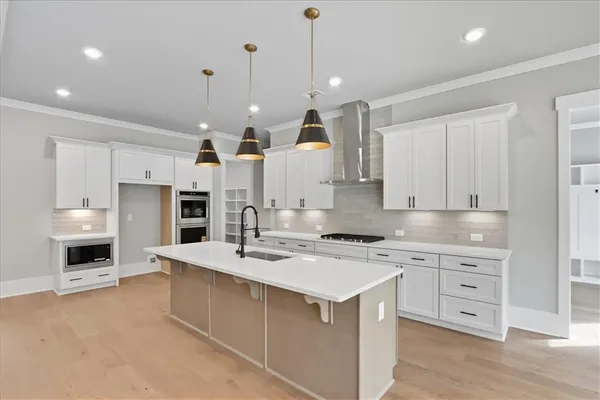 a kitchen with sink stove and white cabinets