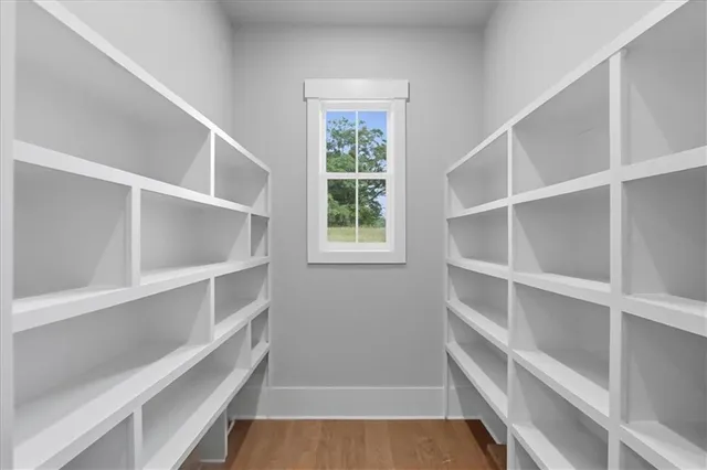 a kitchen with kitchen island granite countertop a sink a counter top space stainless steel appliances and cabinets