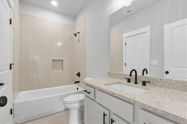 a white house that has a big yard and more windows