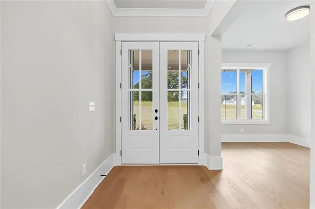a view of an empty room with a fireplace and window