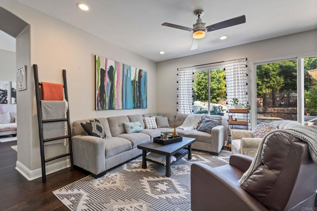 3880 Stoneridge Road Carlsbad, CA 92010 - Photo 14 of 29 a living room with furniture ceiling fan and a large window