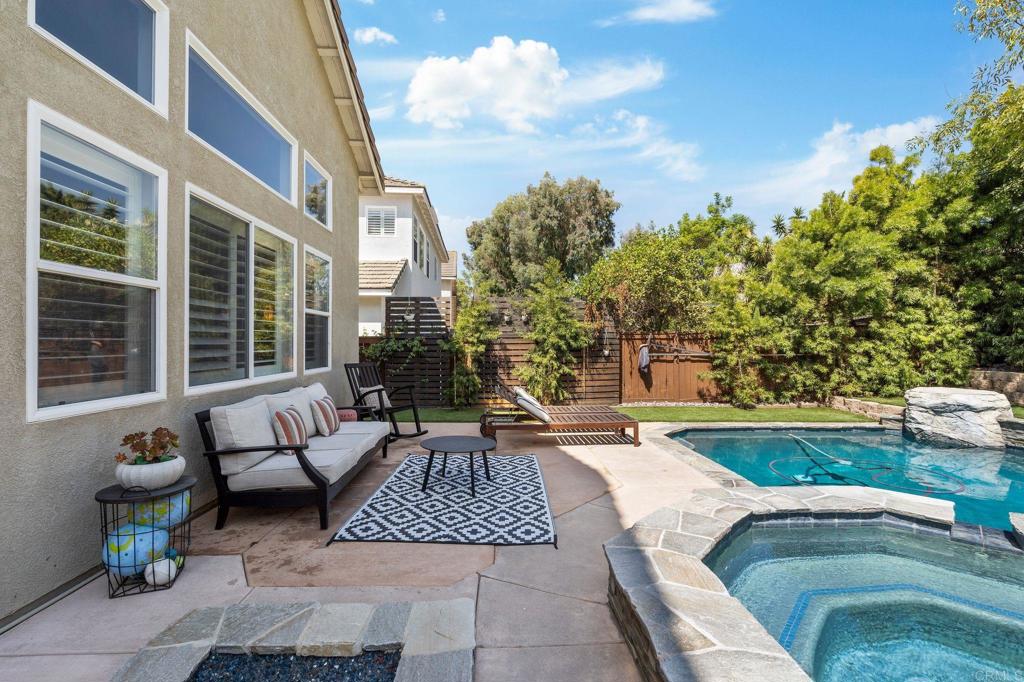 3880 Stoneridge Road Carlsbad, CA 92010 - Photo 19 of 29 a view of patio with couches table and chairs and potted plants