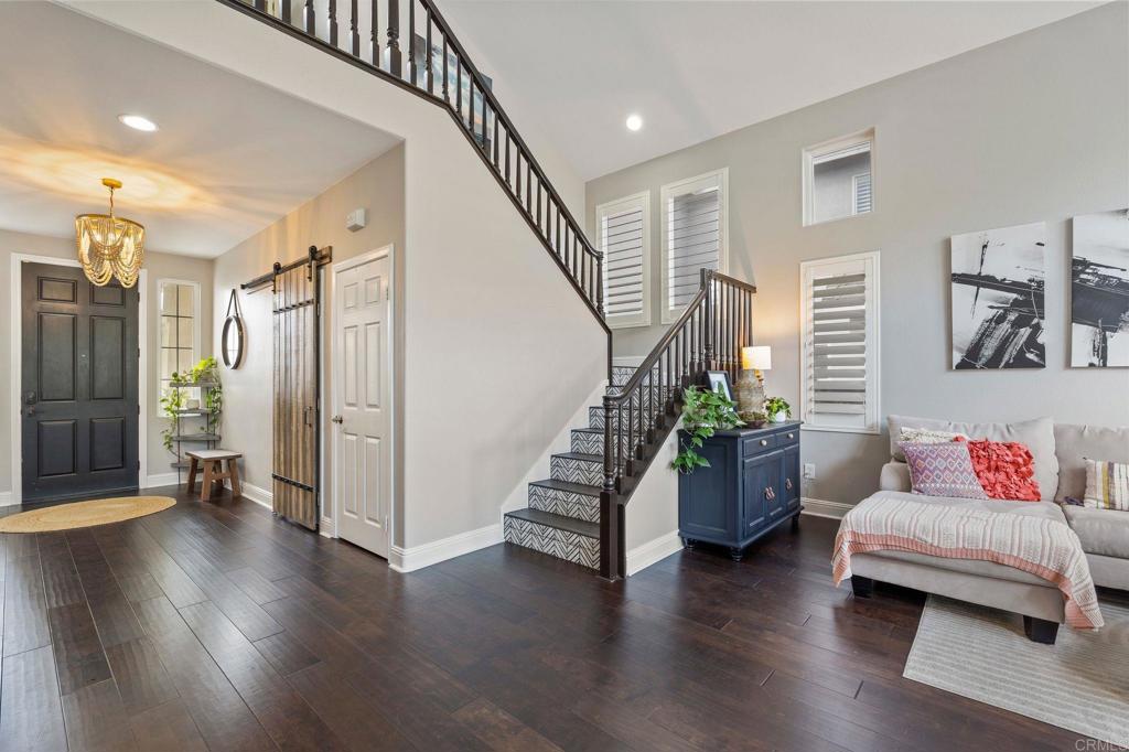 3880 Stoneridge Road Carlsbad, CA 92010 - Photo 2 of 29 a hallway with stairs and a couch