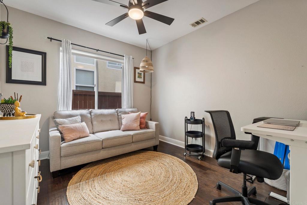 3880 Stoneridge Road Carlsbad, CA 92010 - Photo 21 of 29 a living room with furniture and a wooden floor