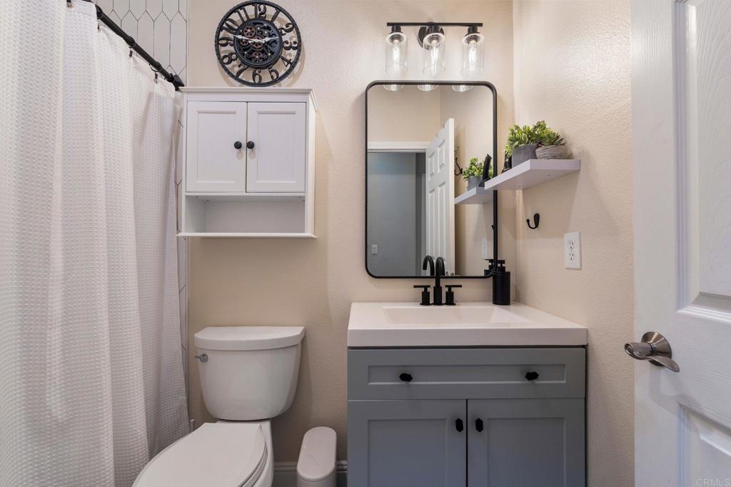 3880 Stoneridge Road Carlsbad, CA 92010 - Photo 22 of 29 a bathroom with a toilet sink and mirror