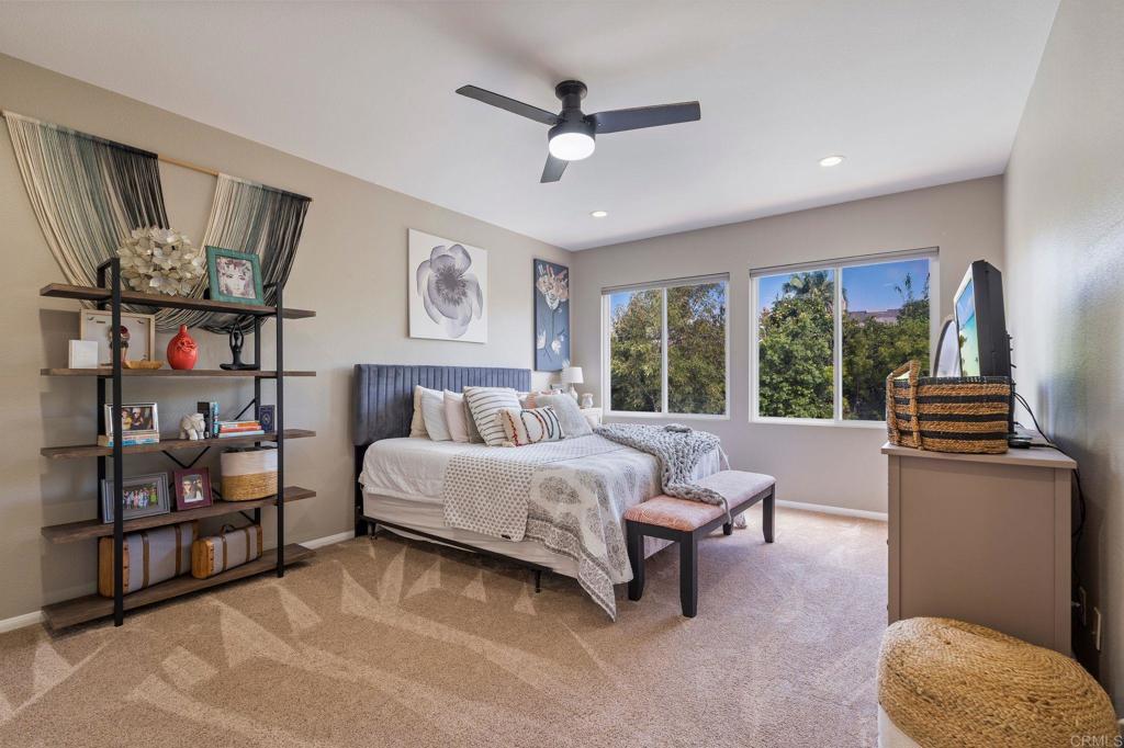 3880 Stoneridge Road Carlsbad, CA 92010 - Photo 24 of 29 a spacious bedroom with a bed a couch and a large window