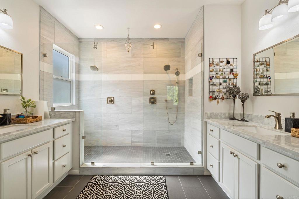 3880 Stoneridge Road Carlsbad, CA 92010 - Photo 25 of 29 a bathroom with a shower sink and mirror