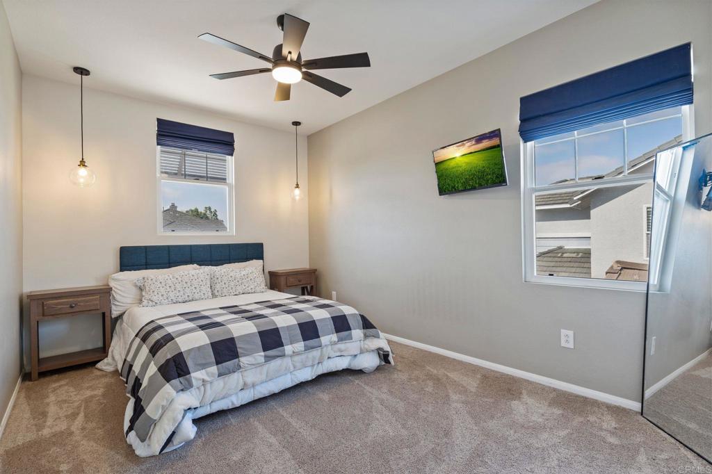 3880 Stoneridge Road Carlsbad, CA 92010 - Photo 27 of 29 a bedroom with a bed and a ceiling fan