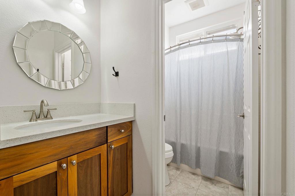 3880 Stoneridge Road Carlsbad, CA 92010 - Photo 28 of 29 a bathroom with a sink a toilet and a mirror