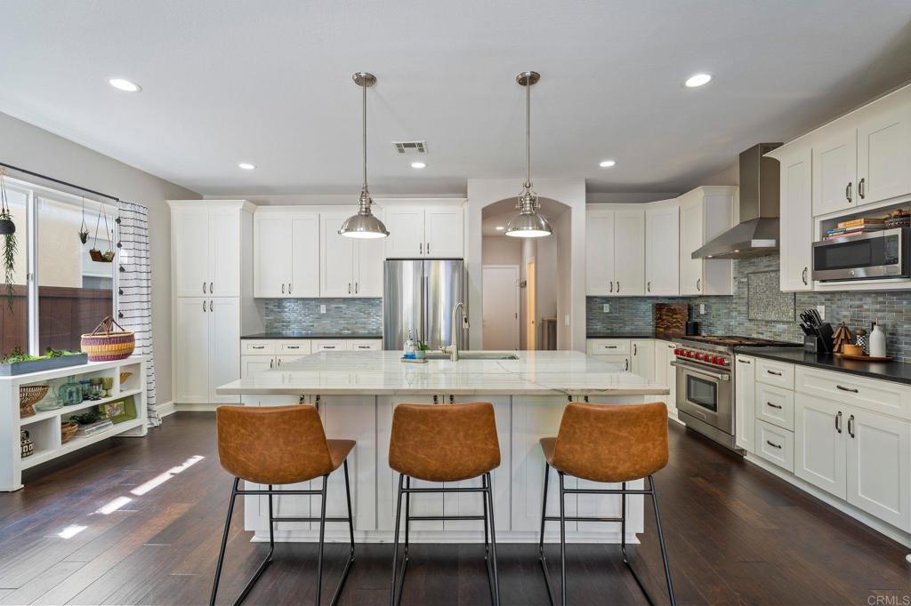 3880 Stoneridge Road Carlsbad, CA 92010 - Photo 7 of 29 a large kitchen with kitchen island a large island in the center