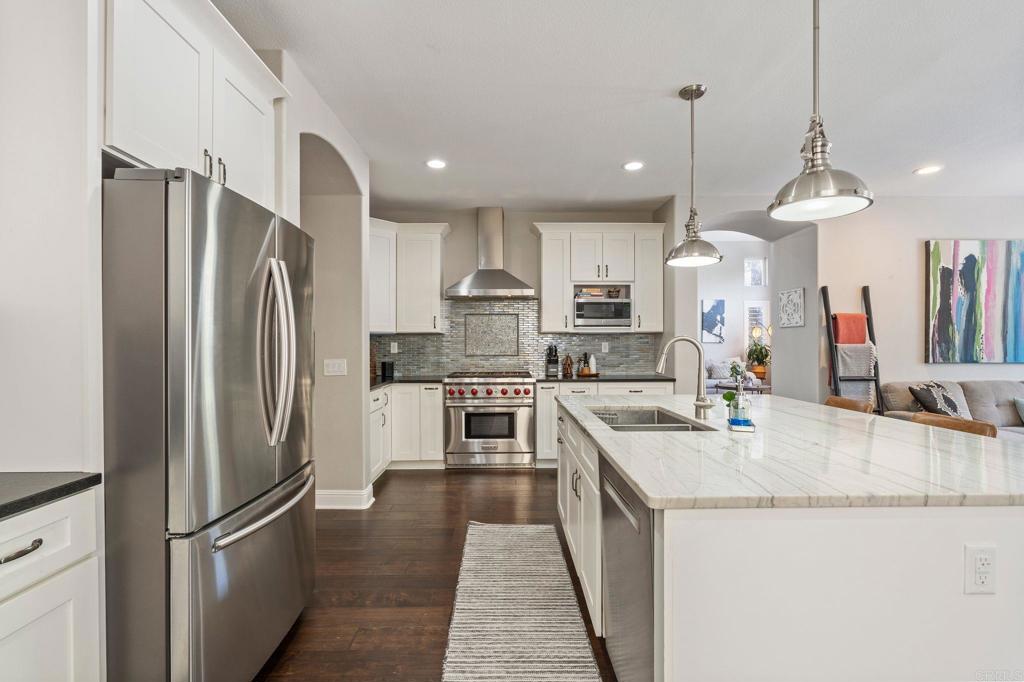 3880 Stoneridge Road Carlsbad, CA 92010 - Photo 8 of 29 a kitchen with stainless steel appliances granite countertop a refrigerator a sink a stove and a refrigerator