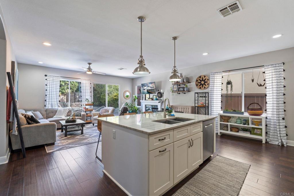 3880 Stoneridge Road Carlsbad, CA 92010 - Photo 10 of 29 a kitchen with stainless steel appliances granite countertop a stove and cabinets