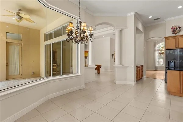 a view of a hallway with a chandelier and chandelier