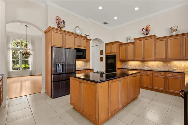 a kitchen with stainless steel appliances granite countertop a refrigerator and a sink