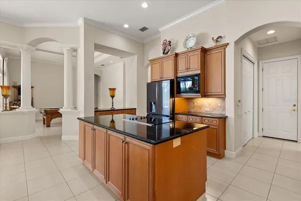 a kitchen with granite countertop a sink and cabinets