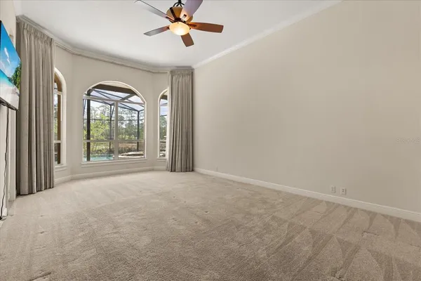a view of a room with large windows and a flat screen tv