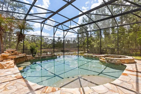 a view of a house with a swimming pool and sitting area