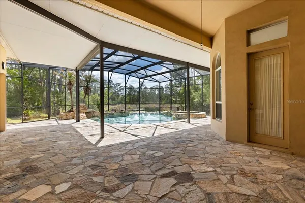 a view of a swimming pool with a patio