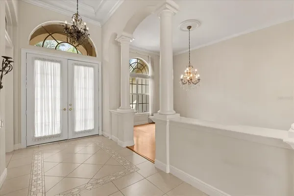 a view of a chandelier cabinet and windows