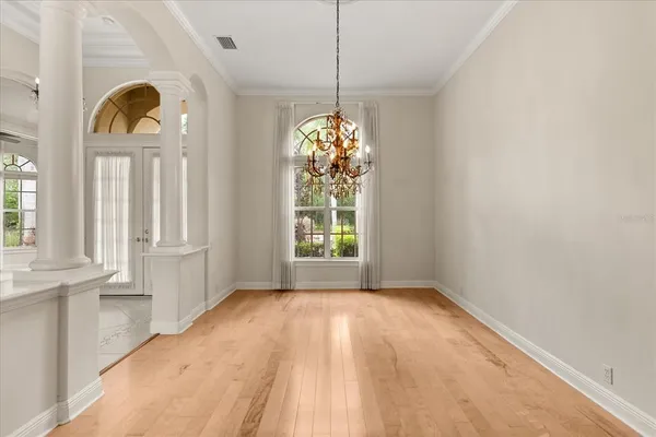 a view of a room with window and chandelier