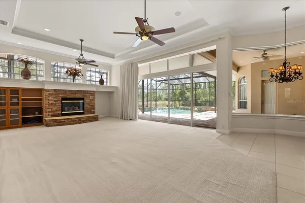 a view of an empty room with a fireplace and a window