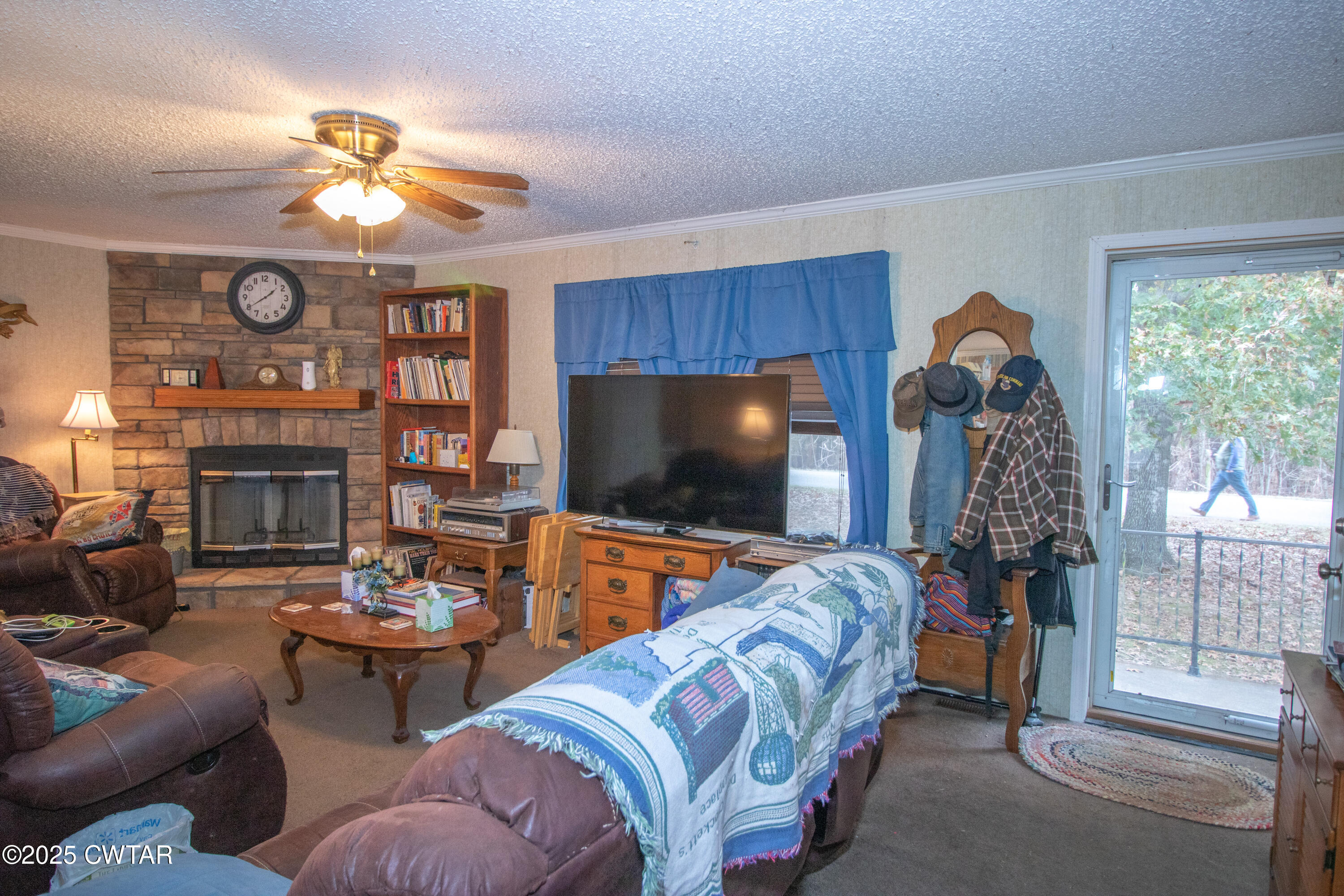 6599 Chestnut Bluff Road Friendship, TN 38034 - Photo 11 of 33 a living room with furniture a flat screen tv and a fireplace
