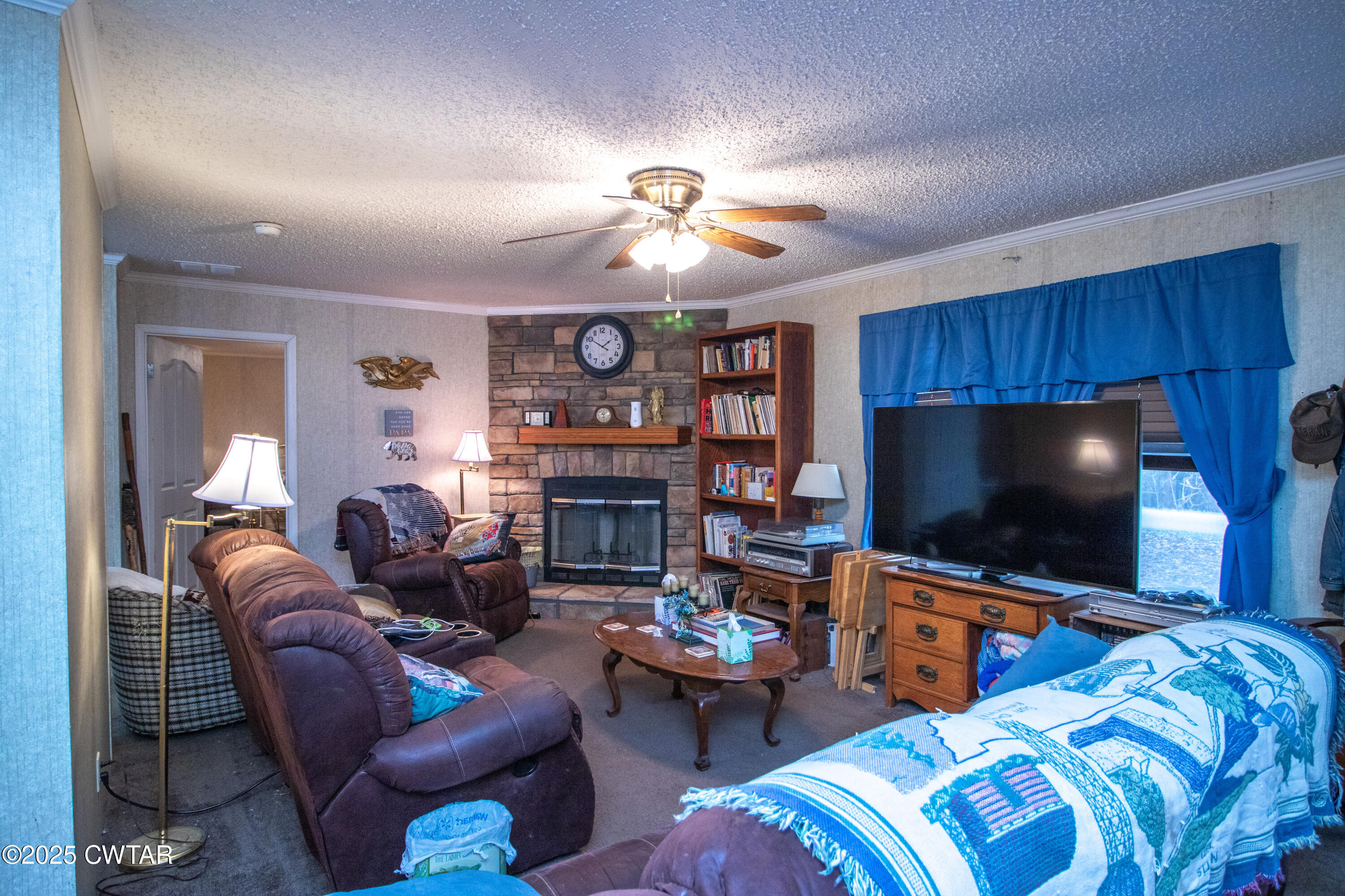 6599 Chestnut Bluff Road Friendship, TN 38034 - Photo 12 of 33 a living room with furniture a flat screen tv and a fireplace