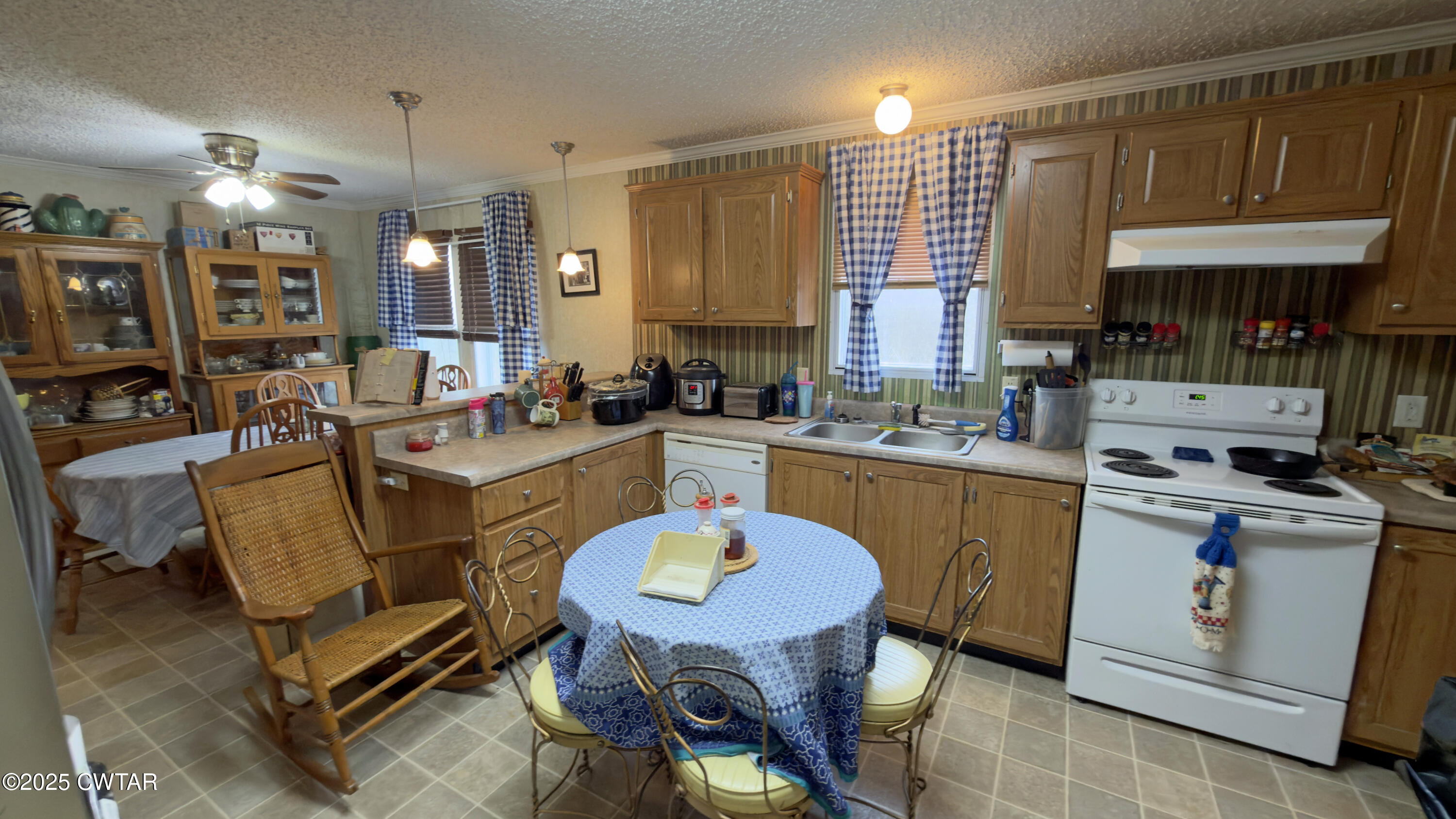 6599 Chestnut Bluff Road Friendship, TN 38034 - Photo 15 of 33 a kitchen with stainless steel appliances granite countertop a stove a sink dishwasher and a dining table with cabinets
