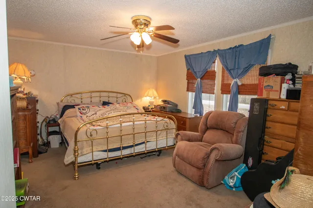 a bedroom with bed and a chandelier