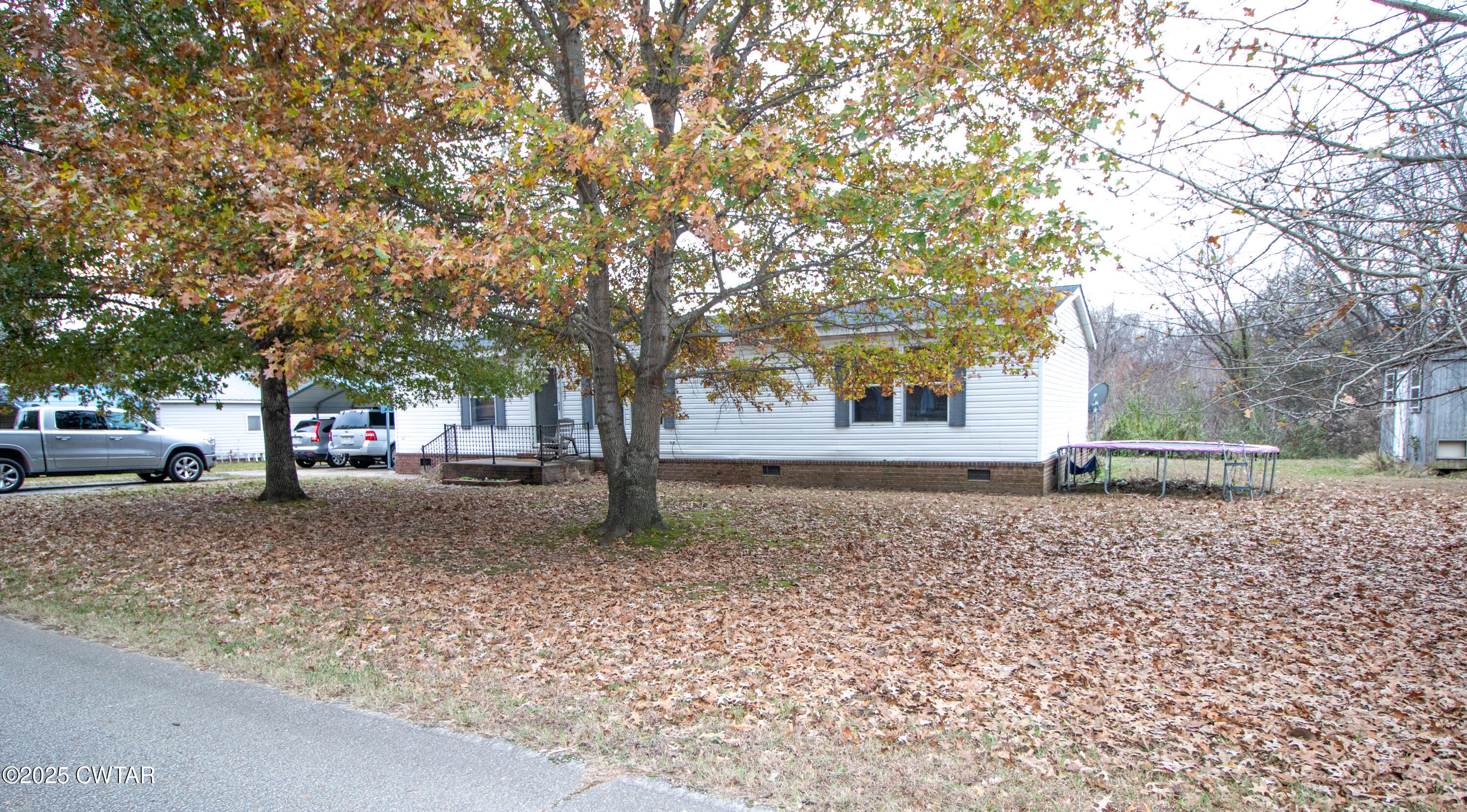 6599 Chestnut Bluff Road Friendship, TN 38034 - Photo 2 of 33 a house with trees in front of it