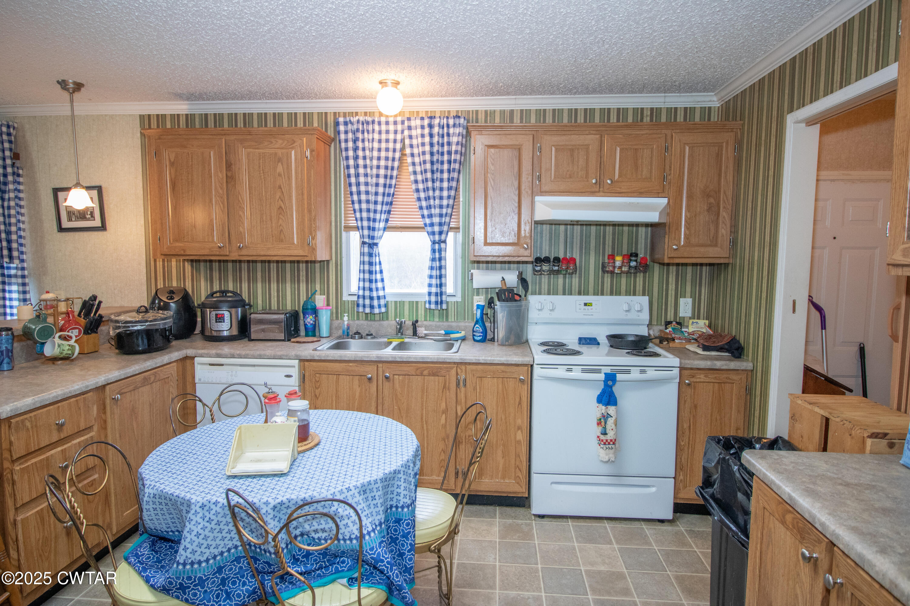 6599 Chestnut Bluff Road Friendship, TN 38034 - Photo 27 of 33 a kitchen with a stove a sink and a refrigerator