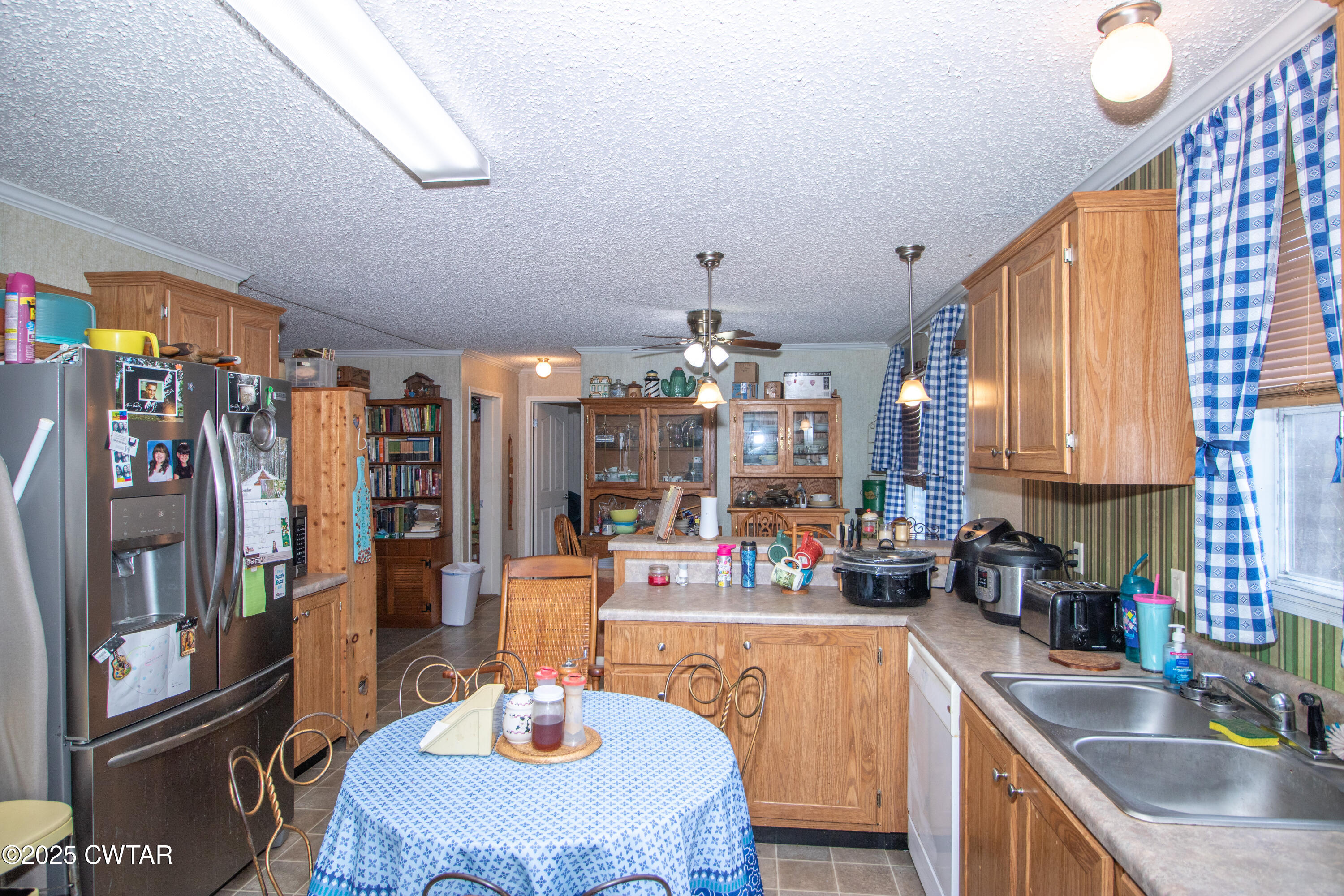 6599 Chestnut Bluff Road Friendship, TN 38034 - Photo 31 of 33 a kitchen with stainless steel appliances granite countertop a sink dishwasher and cabinets with wooden floor