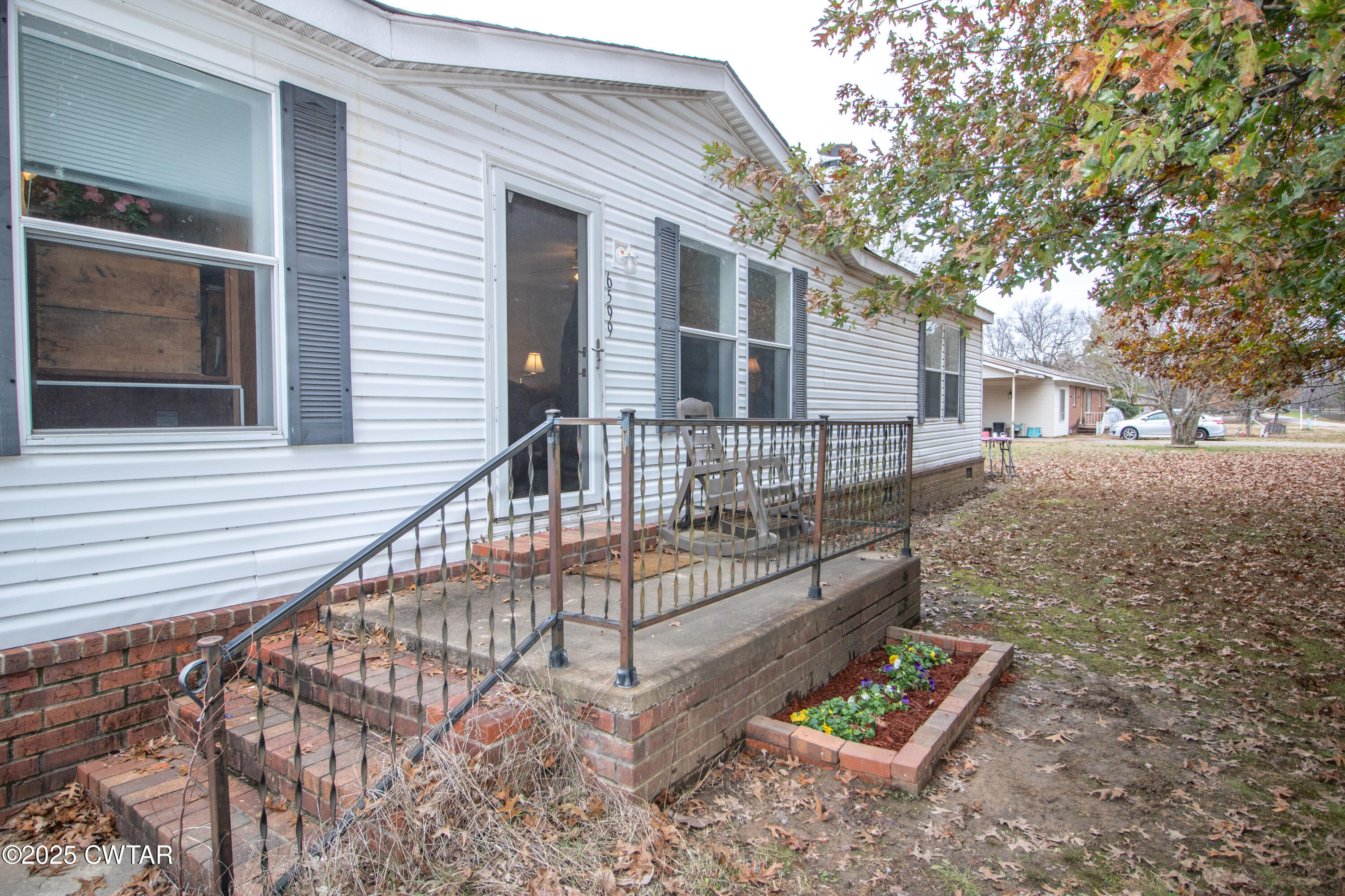 6599 Chestnut Bluff Road Friendship, TN 38034 - Photo 5 of 33 a view of house with a small yard and wooden fence