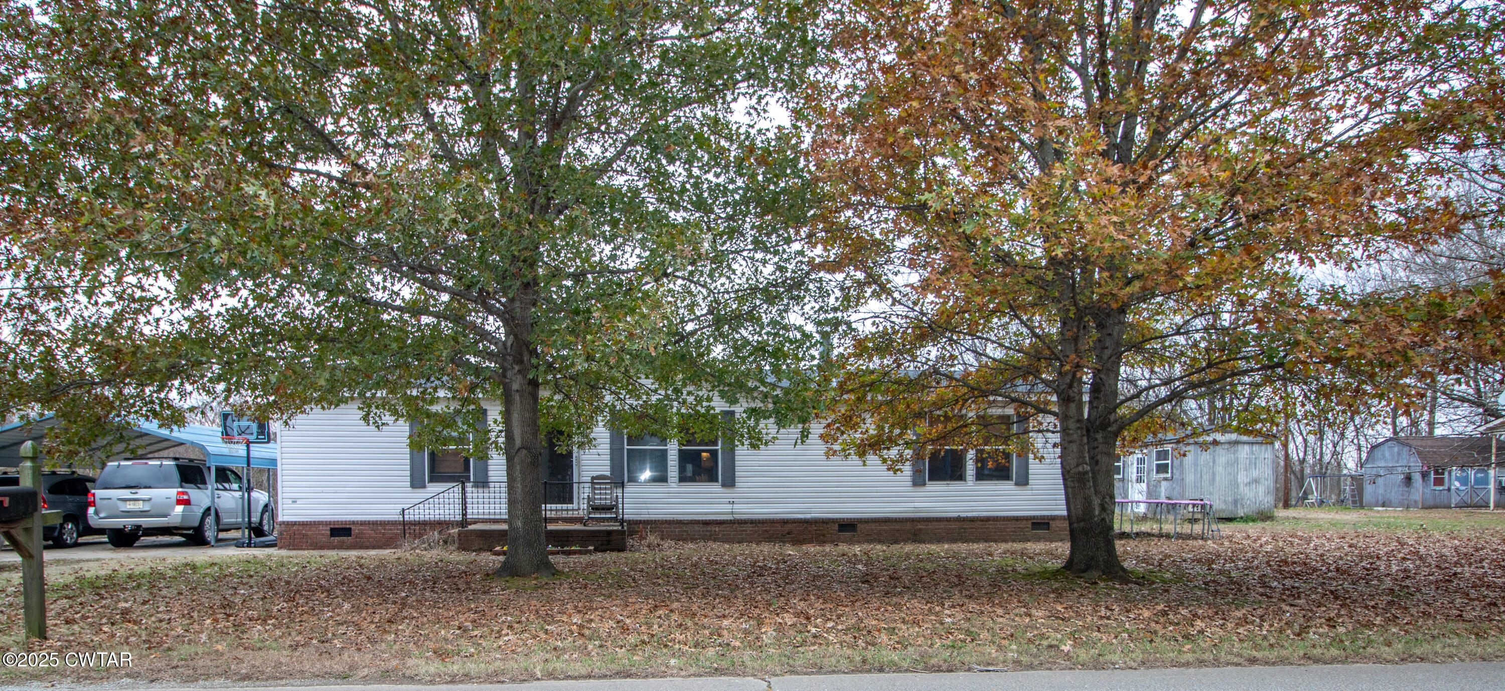 6599 Chestnut Bluff Road Friendship, TN 38034 - Photo 6 of 33 a tree in front of a white house