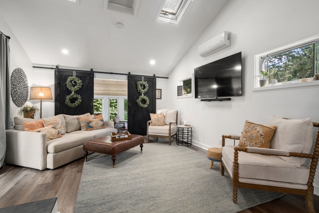 69 Wellesley Rd Extension Natick, MA 01760 - Photo 13 of 30 a living room with furniture and a flat screen tv