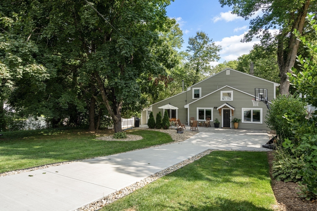 69 Wellesley Rd Extension Natick, MA 01760 - Photo 26 of 30 a front view of a house with a yard