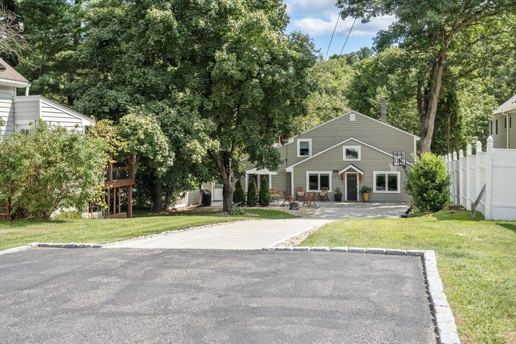 69 Wellesley Rd Extension Natick, MA 01760 - Photo 29 of 30 a front view of house with yard and green space
