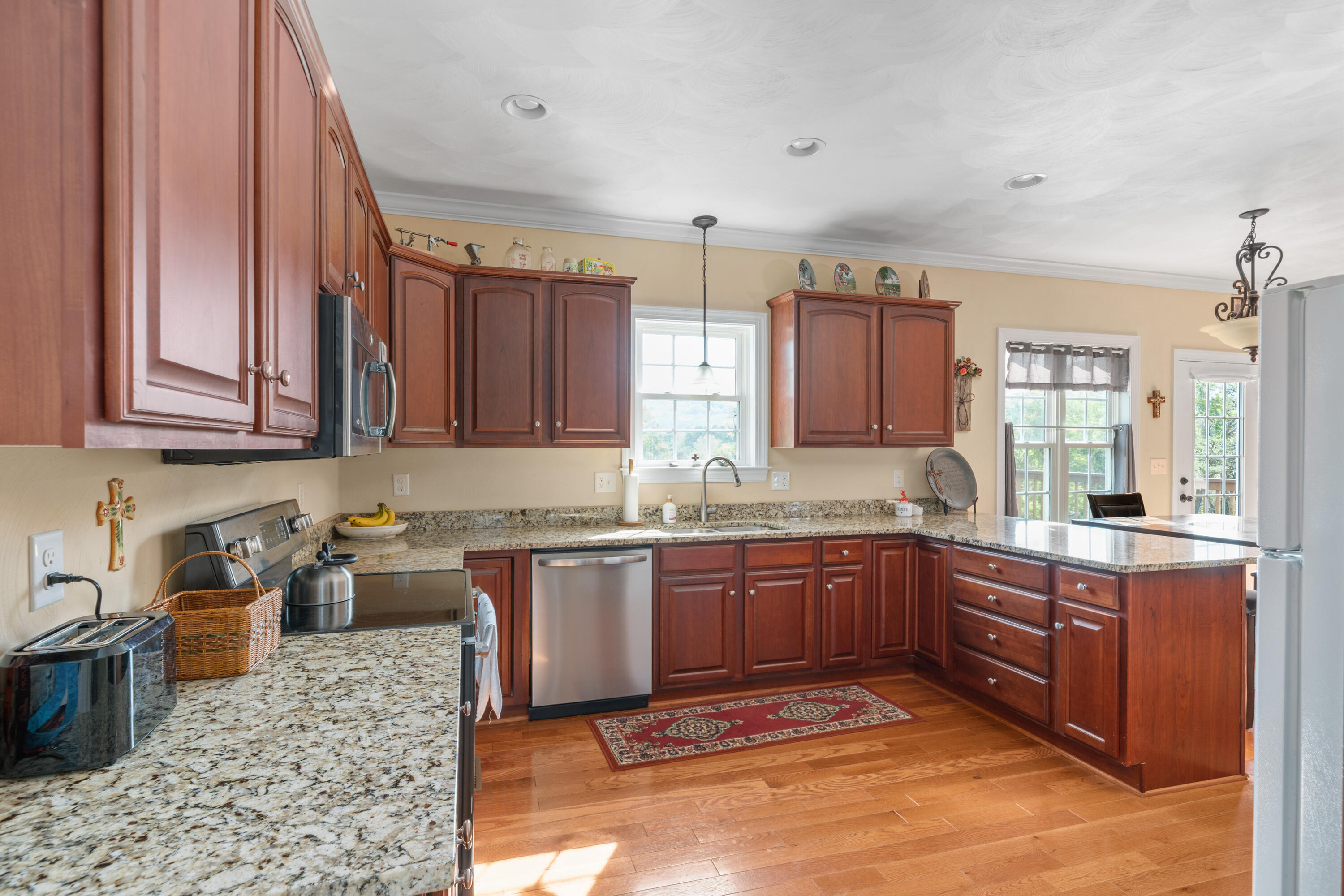 250 Thornblade Way Blue Ridge, VA 24064 - Photo 13 of 31 a kitchen with granite countertop sink stove and cabinets