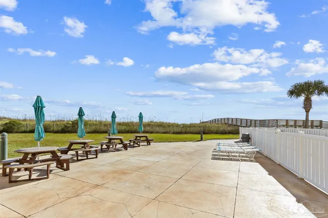 a view of a swimming pool and an outdoor seating