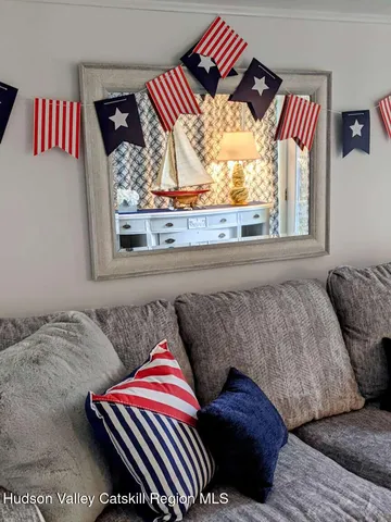 a bedroom with a bed and painting on the wall