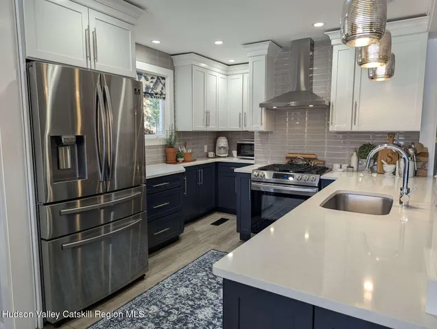 a kitchen with a sink stainless steel appliances and cabinets