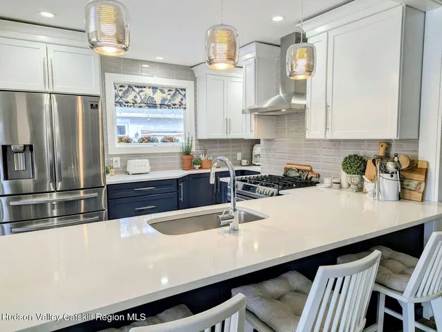 a kitchen with stainless steel appliances a sink and stove