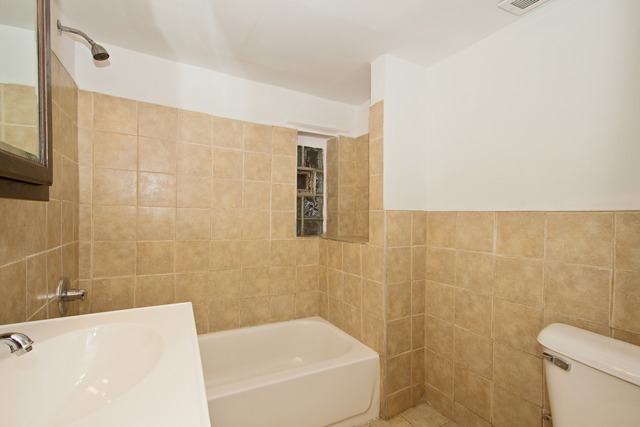 1512 South Springfield Avenue Chicago, IL 60623 - Photo 11 of 13 a bathroom with a bathtub and a toilet