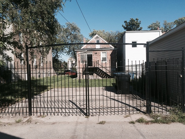 1512 South Springfield Avenue Chicago, IL 60623 - Photo 13 of 13 a view of a house with a wooden fence