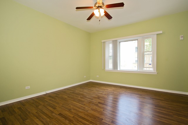1512 South Springfield Avenue Chicago, IL 60623 - Photo 6 of 13 a view of empty room with wooden floor and fan