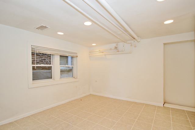 1512 South Springfield Avenue Chicago, IL 60623 - Photo 9 of 13 an empty room with windows