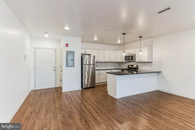 a kitchen with stainless steel appliances a refrigerator sink and microwave