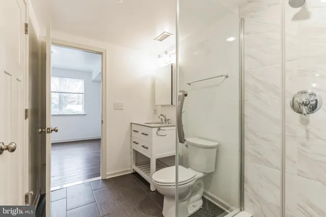 a bathroom with a toilet a sink and shower